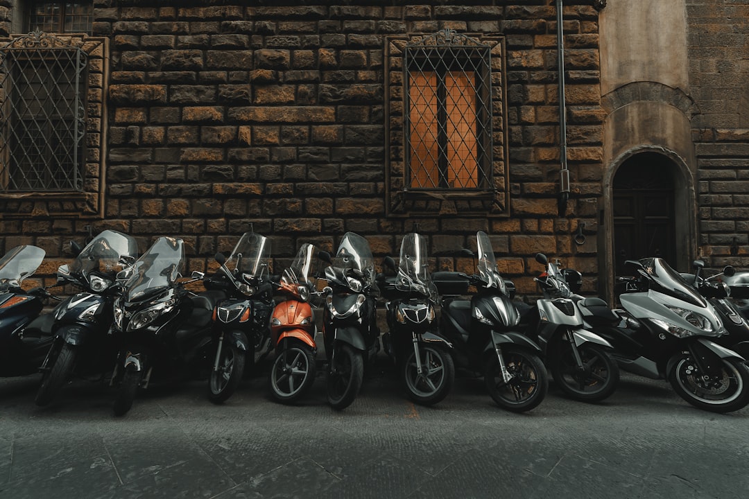 Motor bikes lining the street in Florence, Italy